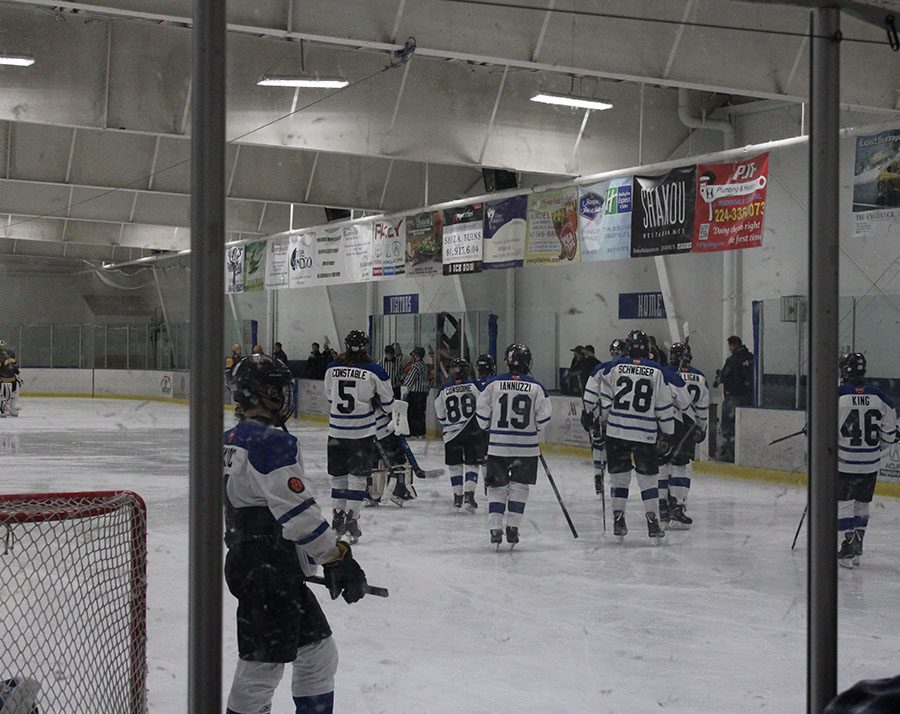 The players head to the bench after warm-ups, in anticipation of the game. 