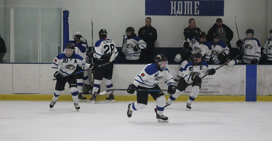 Changing lines, (from left to right) junior Carson Darnall and seniors Brendan King and Kyle Junkunc head back onto the ice.