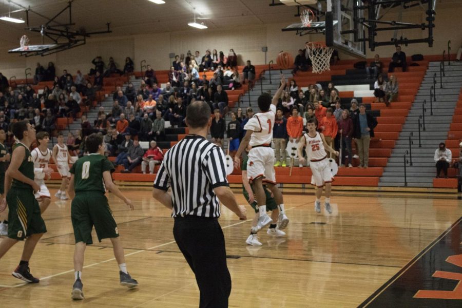 Senior Dominic Quigley makes a layup at the very end of the game, further securing the win for LHS.