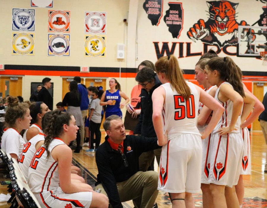 Coach, Greg Pedersen gives the team a talk during a time-out called by LHS.