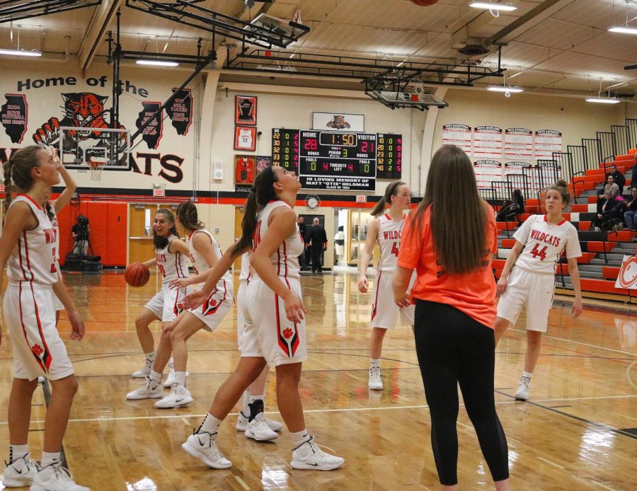 The team shoots baskets 
to warm up before returning to the game.