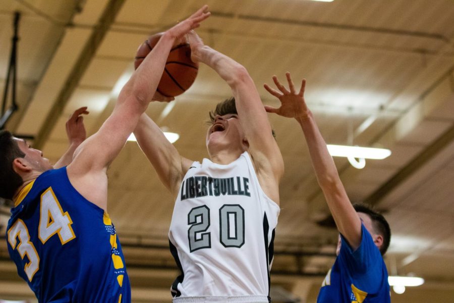 Junior Patrick Graham elevates to the basket while being defended from both sides.