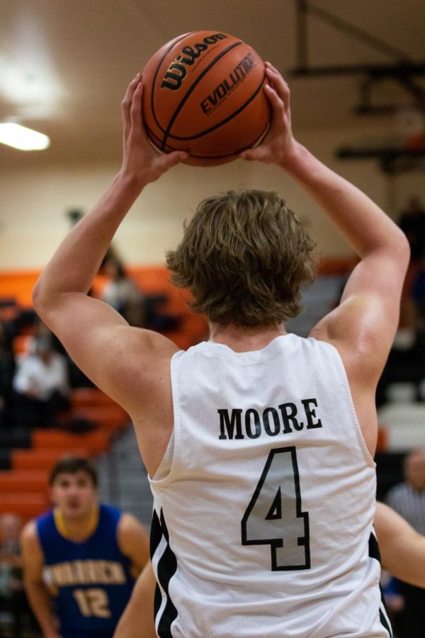 Junior Will Moore grips the ball, looking for a way to pass inside the paint.