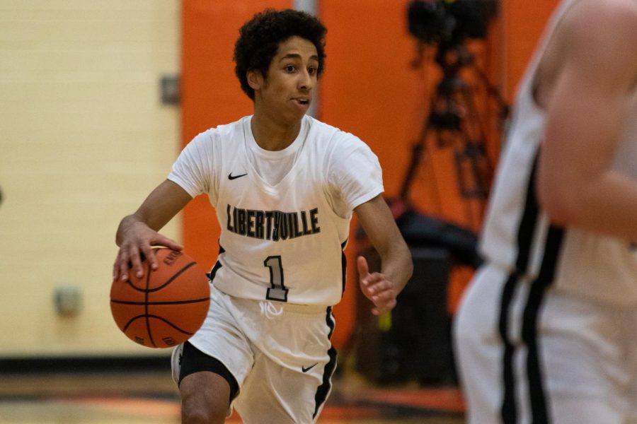 Driving towards the hoop, senior captain Dominic Quigley keeps control of the ball looking to increase the Wildcats’ lead in the beginning of the game.