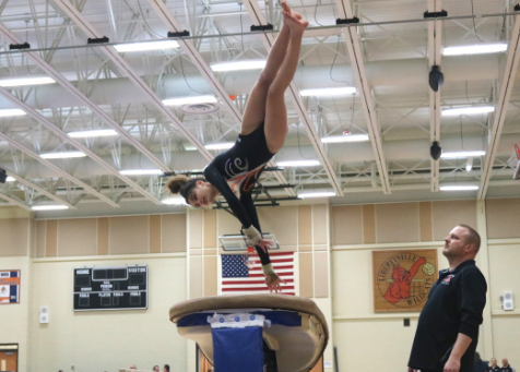 Freshman Rachel Bertsch leaps onto the vault and, using her hands, springs herself up to land perfectly on the mat.