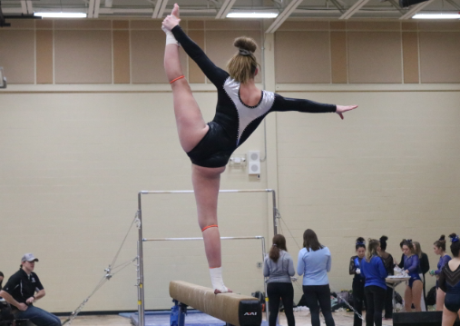 Swanson performs a leg hold straight up on the beam for about two seconds.