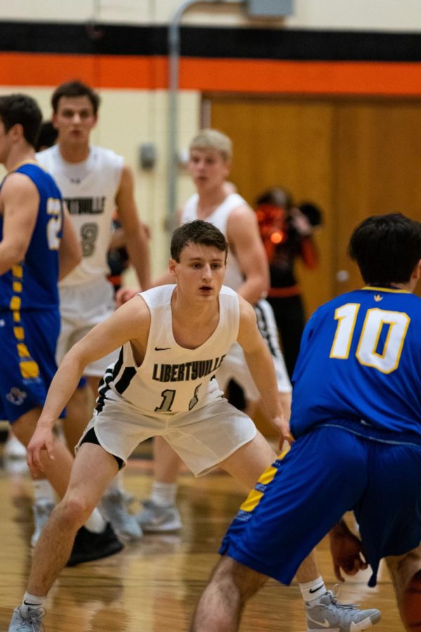 The Cats’ defense looks to lock down the Warren offense, starting with the point guard, senior captain Josh Steinhaus (11).