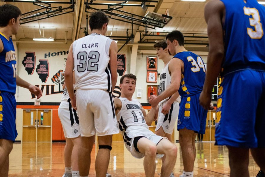 Battling until the very end, Steinhaus gets helped to his feet from players on both teams after being fouled attempting to even up the score.