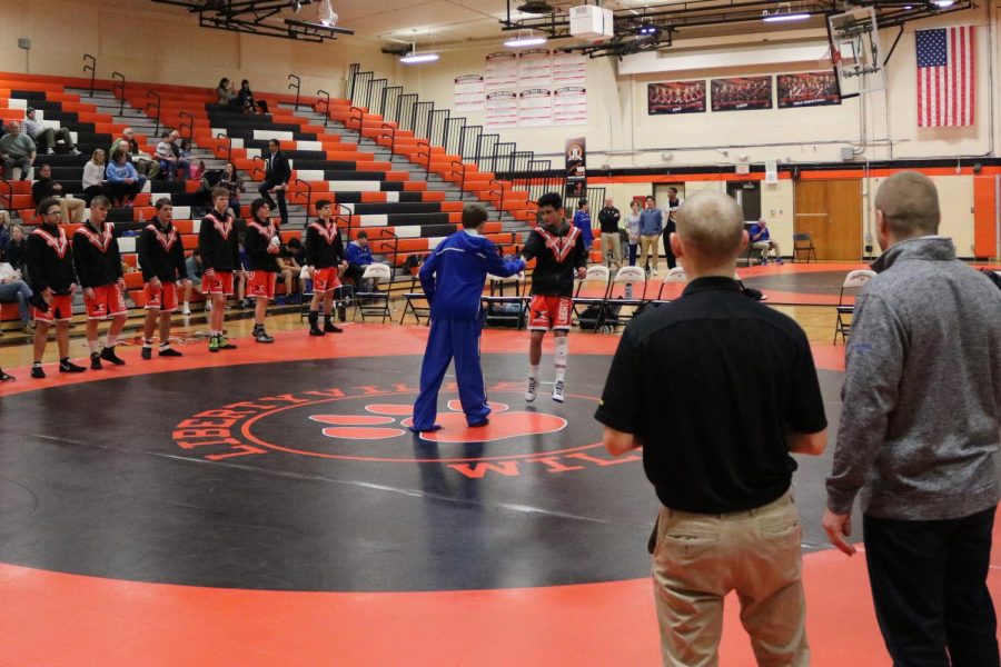 Before the meet starts, competitors from Libertyville and Lake Forest greet each other.