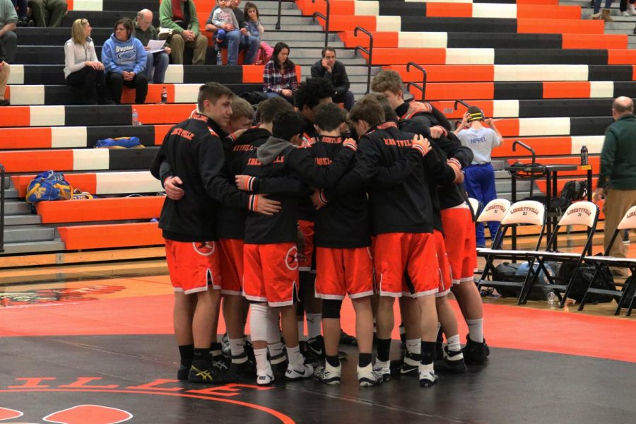 The Libertyville varsity team huddles before the matches begin.