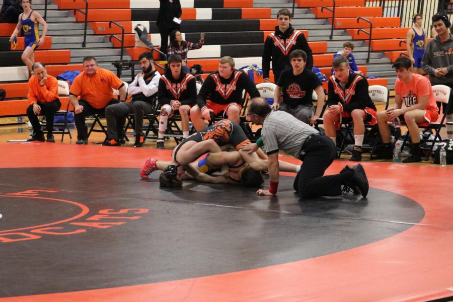 Freshman Michael Rocco attempts to pin the Lake Forest wrestler to the mat. He would later win his match.