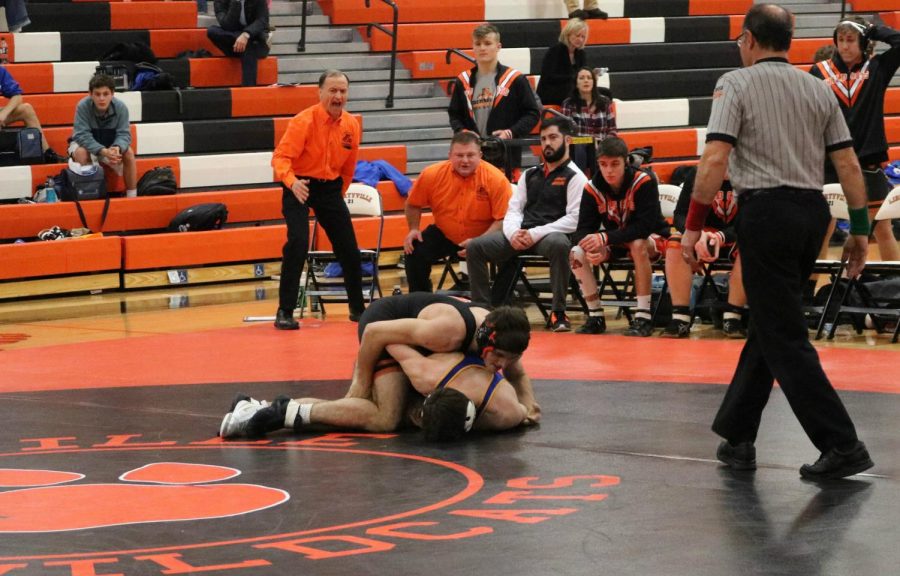 Senior Bennett Whitney brings his opponent down to the mat.