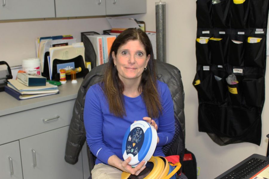 Ms. Alisa Wasserman, one of the school’s nurses, holds an Automated External Defibrillator, which is used to help revive victims of cardiac arrest.