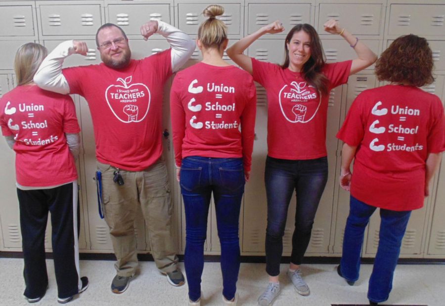 Ms.+Dana+Brady%2C+the+building+representative+of+the+teachers+union+%28and+second+from+the+right%29%2C+poses+with+fellow+teachers+in+their+red+shirts.