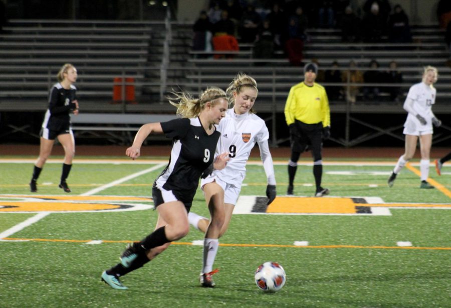 Using her speed to get down field, Miller dodges her defender.