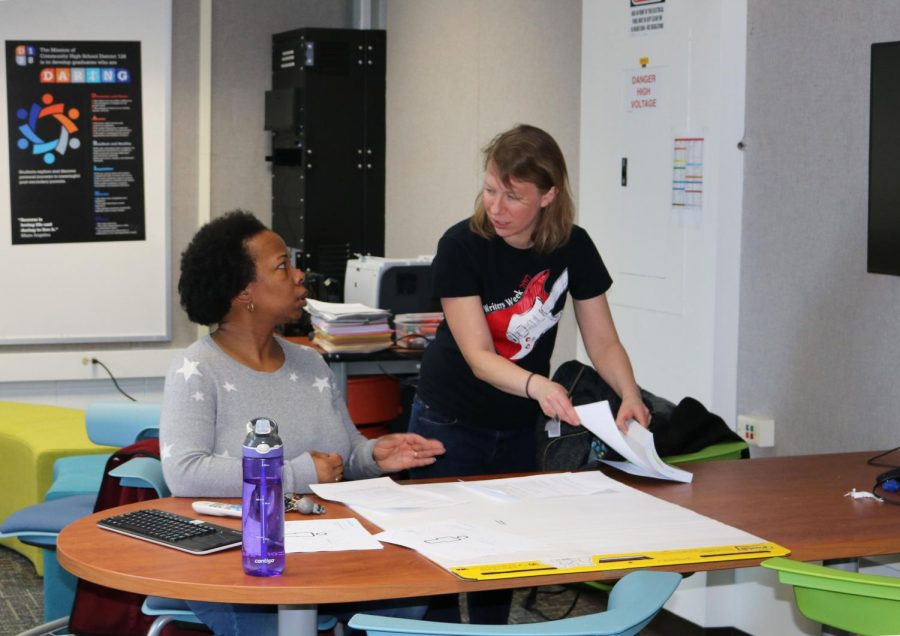 Mrs. Anne Singleton (right), the school’s newly appointed equity leader, discusses the plan for the evening equity meeting for some district staff with fellow English teacher Ms. Sharra Powell. These two teach the class with Ms. Amy Holtsford.