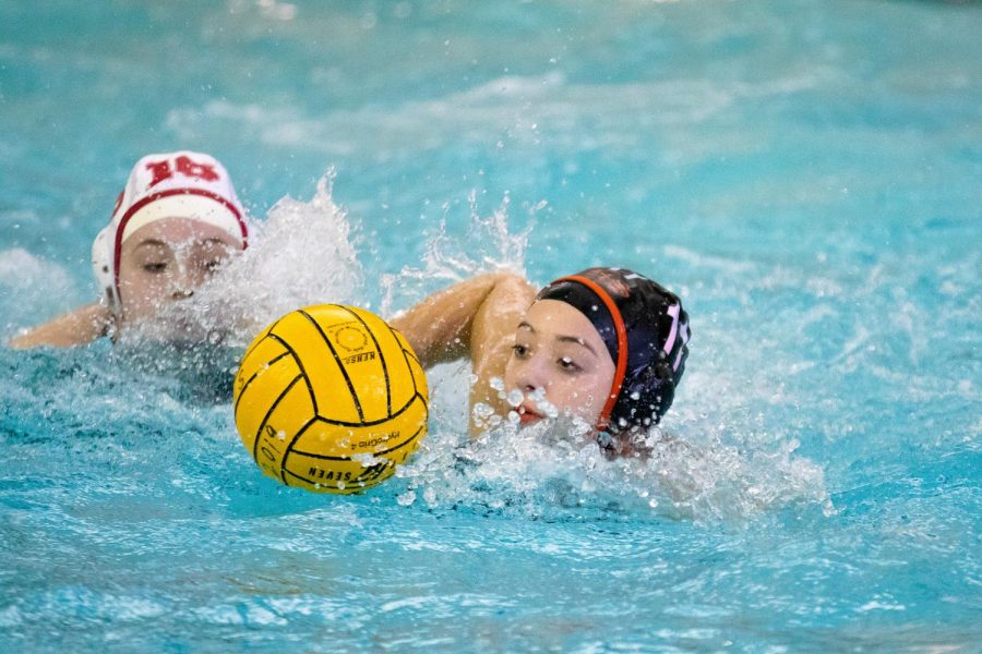 Heard swims with control of the ball, considering her options as she approaches the goal.