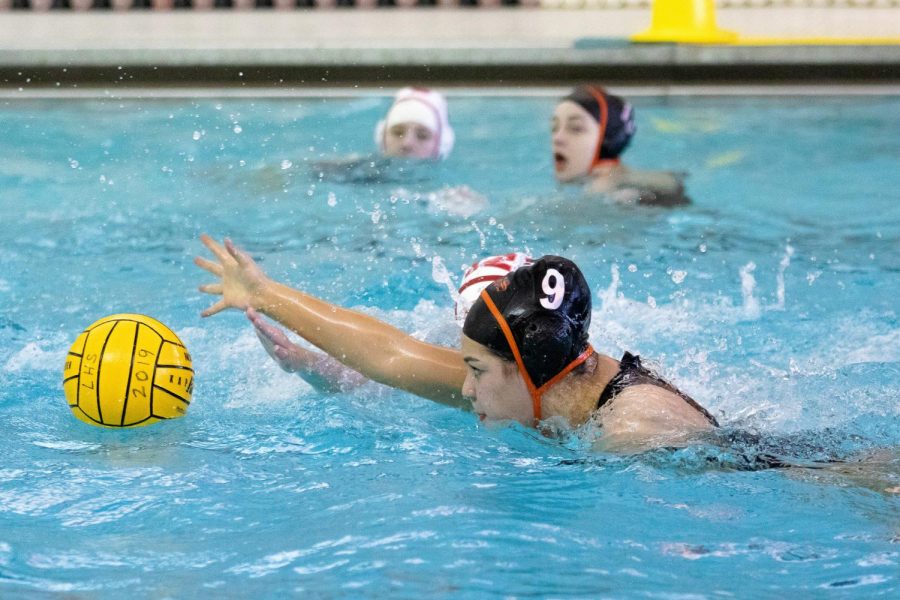 Reaching for the ball, Margaux Scally breaks up a Deerfield attack.