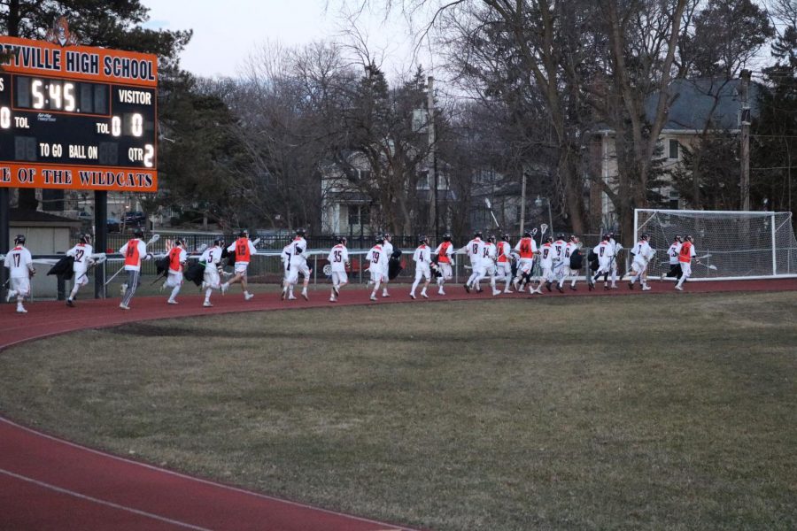 The team runs to the field to get into position before the game starts.