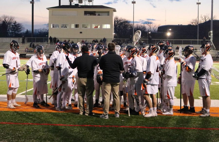 Head coach Brady Sullivan gives words of encouragement to the players during the first quarter.