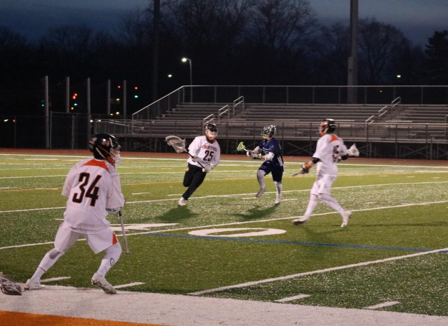 Senior Matthew Wagner (25) returns the ball to his teammates after blocking a shot by Bartlett.