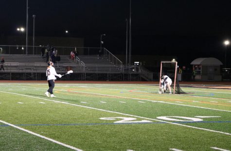 Wagner and junior Wesley Hare, the goalies for the varsity team, practice blocking shots during halftime.