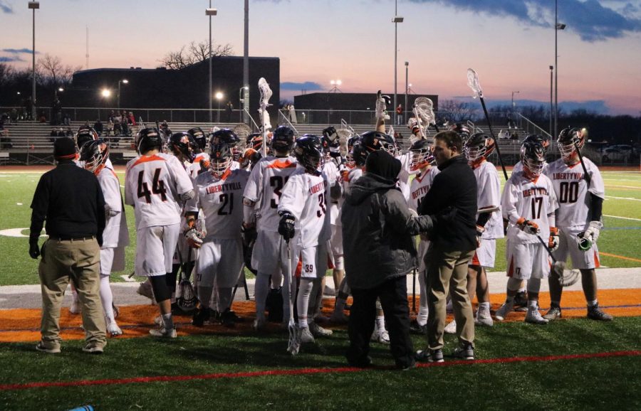 The team breaks their huddle after Coach Sullivan gives them advice during the first quarter.