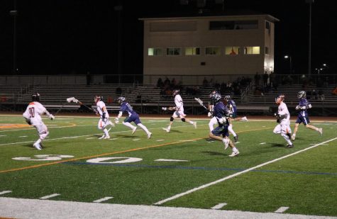 The LHS team sprints toward the goal after stealing the ball from Bartlett.