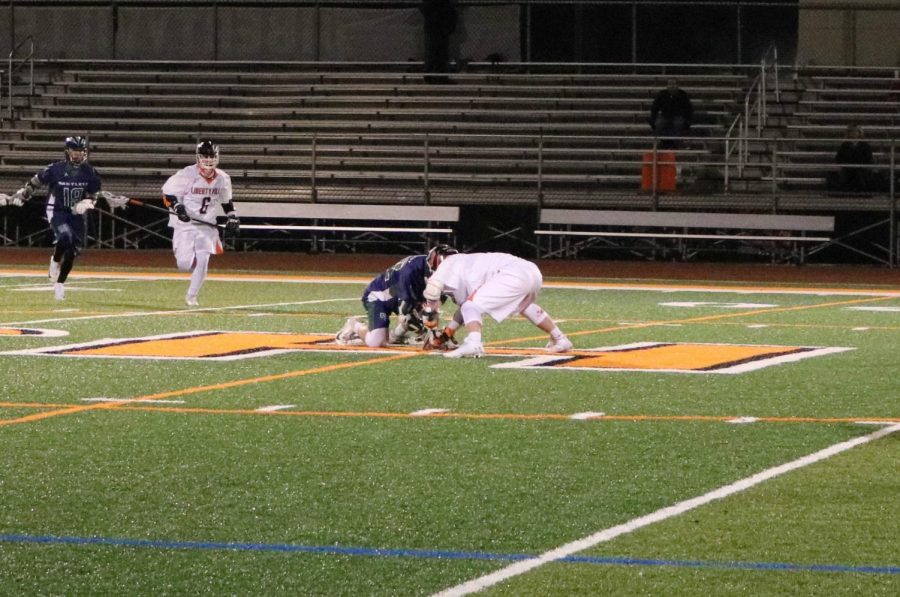 On the faceoff, one player from each team attempts to wrestle the ball from the other’s grasp after a goal was scored.