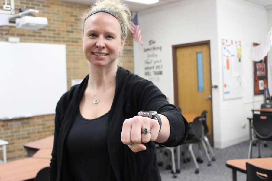 Mrs. Amann holds out her state ring from when she won the championship during her years of high school soccer.