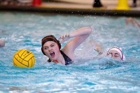 Sophomore Cate McCarty goes for the ball on Deerfield's side of the pool.