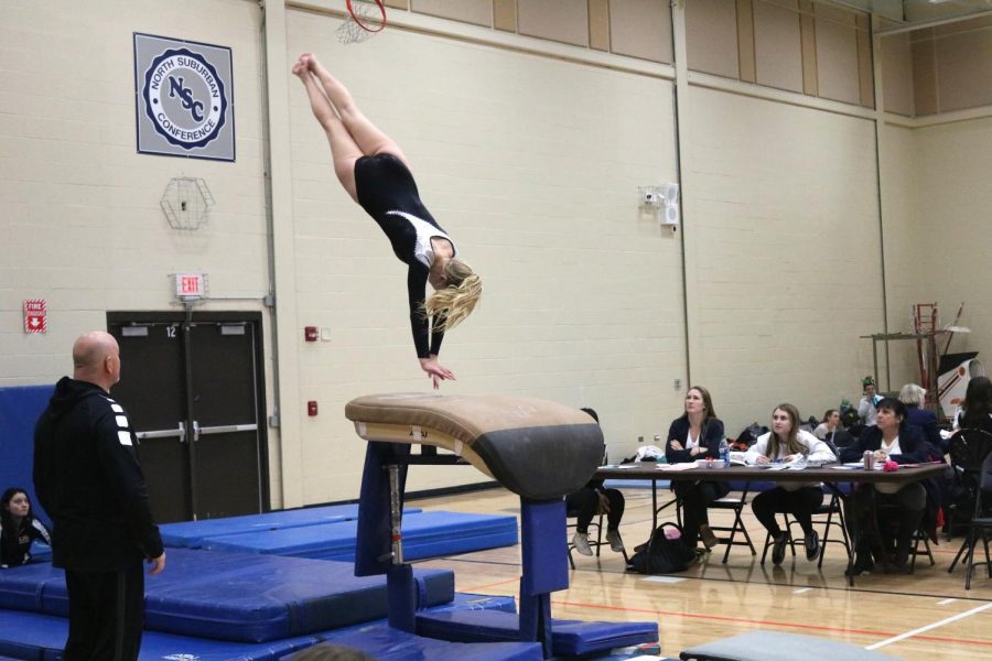 Senior Kylie Ski prepares to land a vault at a girls gymnastics meet.