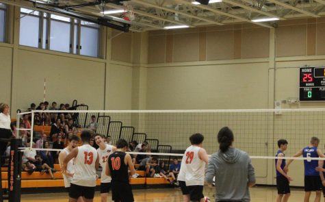 he Wildcats celebrate after securing a tight first-set victory.