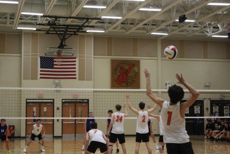 Junior Liam Ness serves the ball in the third set.