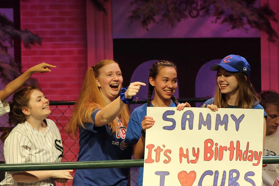 Megan Nostrand, Kate Gerber, Nadia Simpson, and Pearl Temesy act as lively spectators in the stands of Wrigley Field.