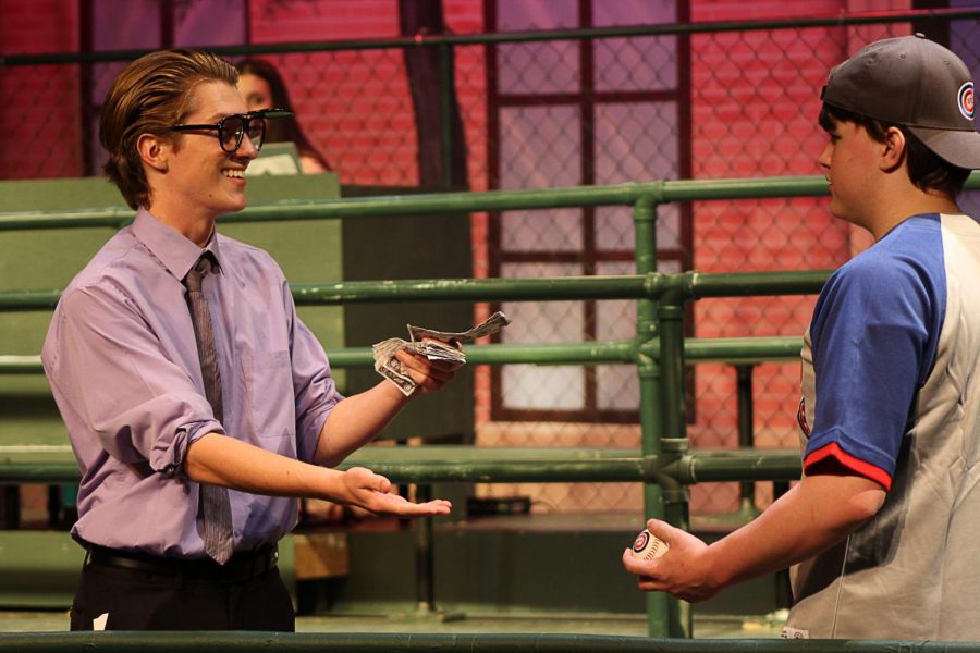 Marvin (Matthew Pavlik) offers Richie (Ryan Kreighbaum) a generous amount of cash in exchange for a home run ball. 