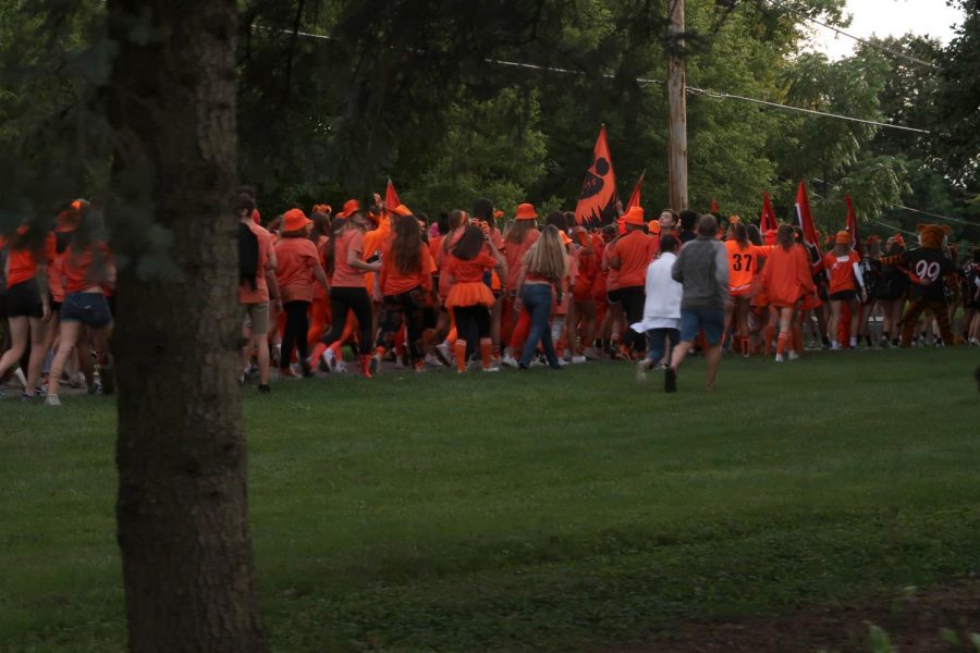 Students enter the North Shore bike path, following the cheerleaders and marching band.