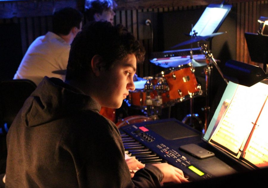 Junior Sebastian Ingino plays the keyboard in the pit orchestra.