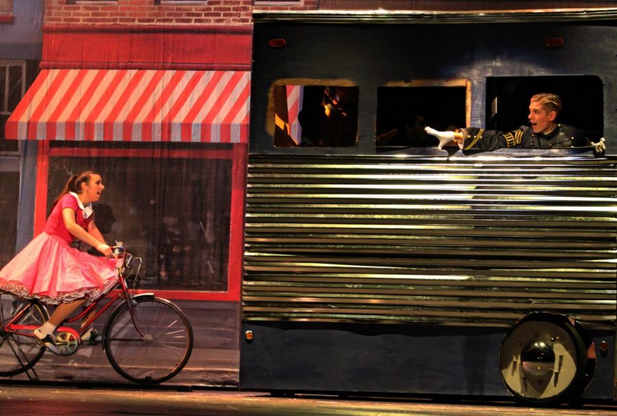 The set crew worked behind the scenes, creating the moving bus and bicycle props used by seniors Sarah Donofrio and Will Anderson.