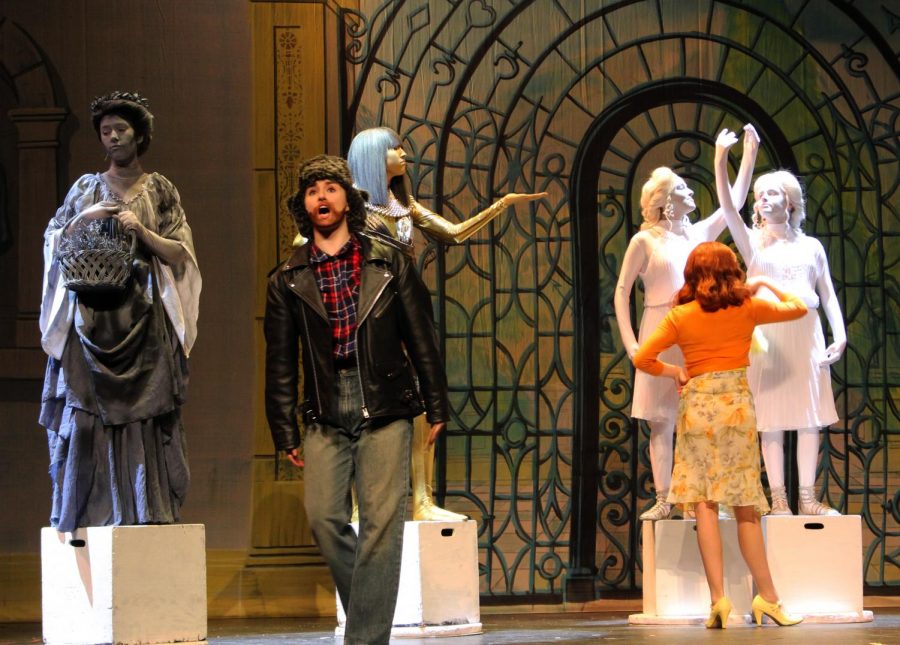 Erdmann dresses up as a man in disguise to win the affection of Sterners character. During this scene at the town museum, ensemble members stood on boxes in the background and later performed as dancing statues.
