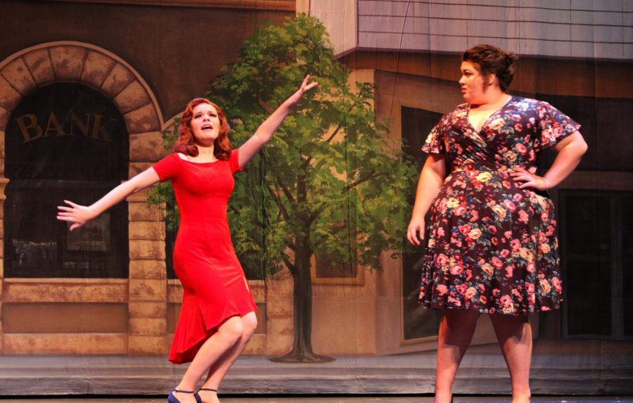 Senior Jessica Schrag shows her character Miss Sandras personality through her dancing as Sylvia, played by junior Mary Piedrahita, watches her.