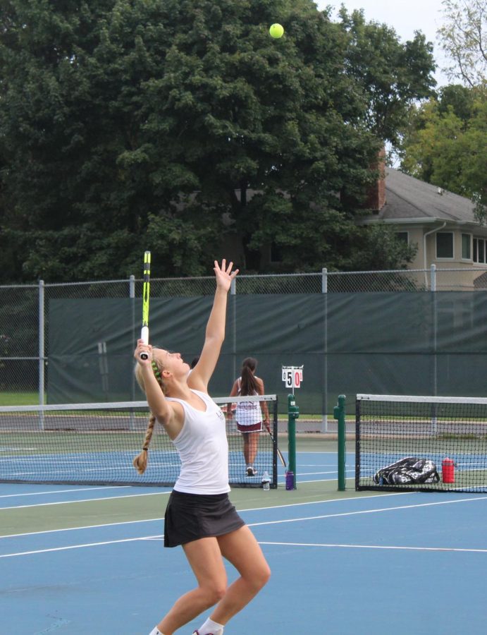 Undefeated freshman singles player Maggie Forkner serves the ball during her last set.