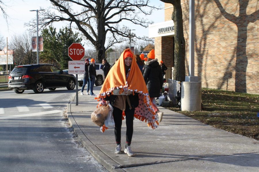 Senior Julia Blockinger carries cans to the truck.