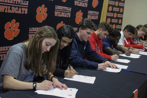 The seniors collectively sign their letters of intent. 