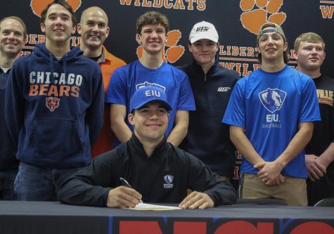 Senior Dylan Drumke’s teammates and coaches watch as he signs his commitment to Eastern Illinois University to play baseball in the fall of 2020. 