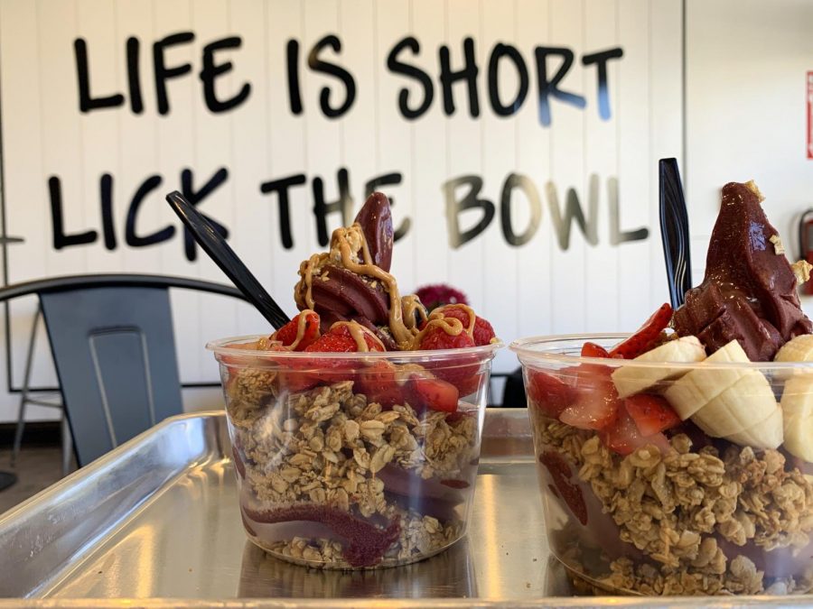 The bowl on the left is the berry bowl, which includes strawberries, blueberries, raspberries, honey and granola with the addition of peanut butter. The bowl on the right is a customized bowl.