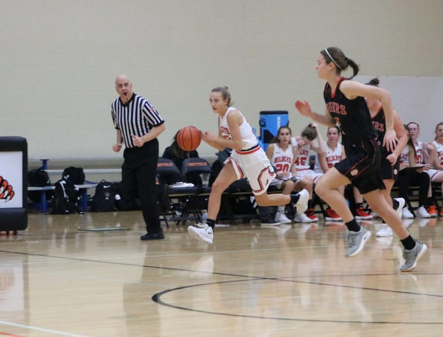 Junior Morgan Spaulding dribbles up the court after Crystal Lake Central makes a basket.