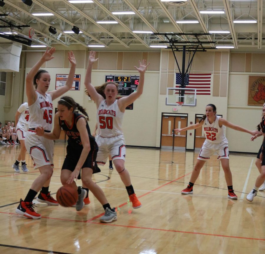 Frea and Crow block their opponent to stop her from scoring or passing.