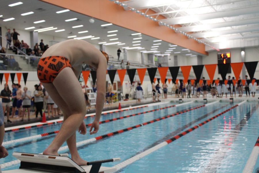 Senior Andrew Baileck stands on the starting block in preparation to take his mark for the 200-yard freestyle.