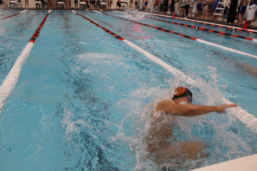 Junior Lawrence Wang does an open turn during his leg of the 200-medley relay.